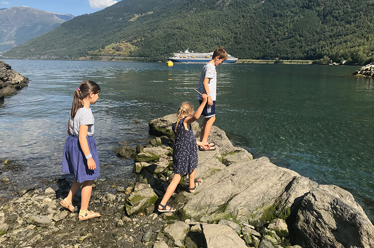 Kinder auf Felsen am Wasser – das gibts während Familienurlaub in Dänemark.