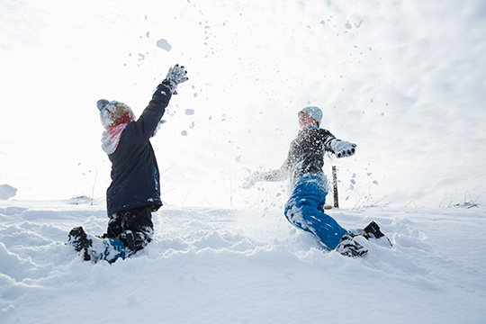 Kinder spielen im Schnee.